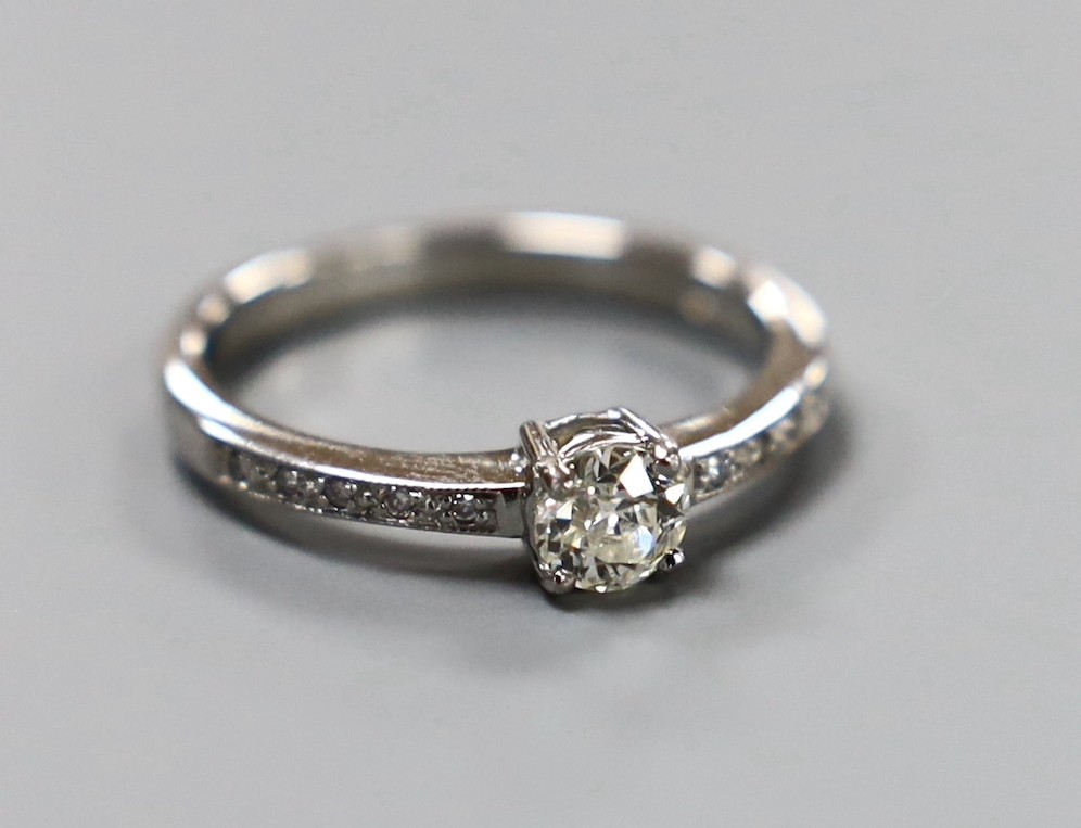 A modern platinum and single stone diamond ring, with diamond set shoulders, size M, gross weight 3.7 grams
